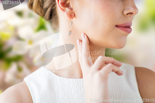 Image of close up of beautiful woman face with gold earring