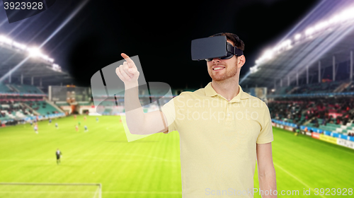 Image of man in virtual reality headset over football field