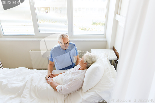 Image of senior couple meeting at hospital ward