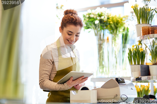 Image of woman with tablet pc computer at flower shop