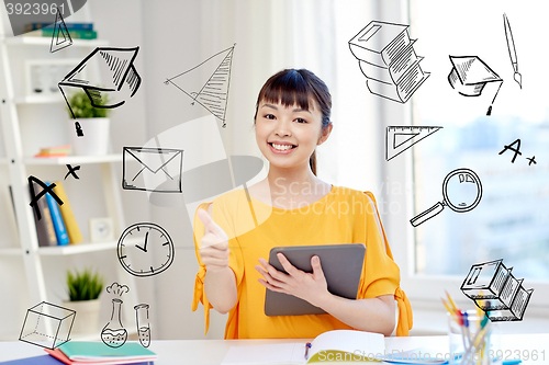 Image of happy asian woman student with tablet pc at home