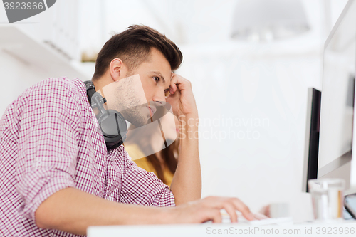 Image of stressed software developer at office