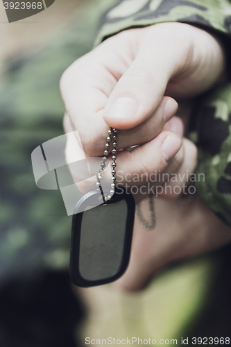 Image of close up of young soldier in military uniform