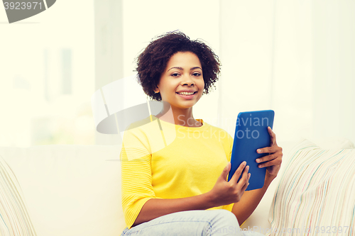 Image of happy african american woman with tablet pc