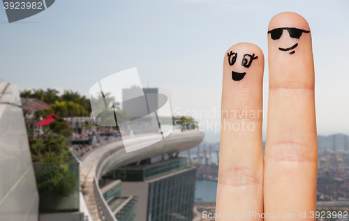 Image of close up of two fingers with smiley faces