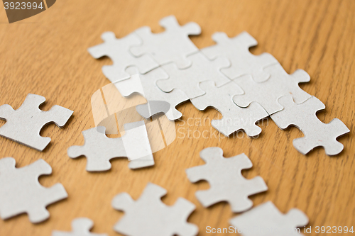 Image of close up of puzzle pieces on wooden surface