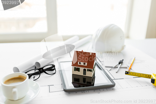 Image of close up of living house model on tablet pc