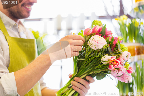 Image of close up of florist man with bunch at flower shop