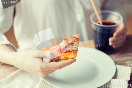 Image of close up of woman with pizza and cola drink