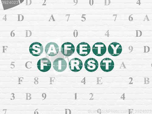 Image of Safety concept: Safety First on wall background