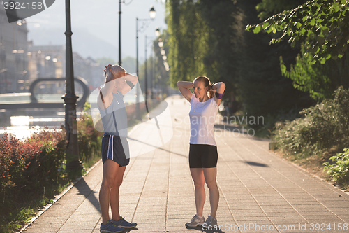 Image of couple warming up and stretching before jogging