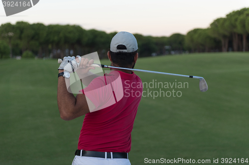 Image of golfer hitting a sand bunker shot on sunset