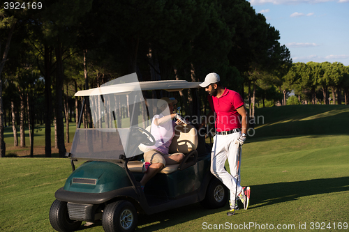 Image of couple in buggy on golf course