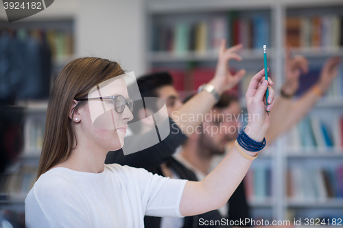 Image of group of students  raise hands up