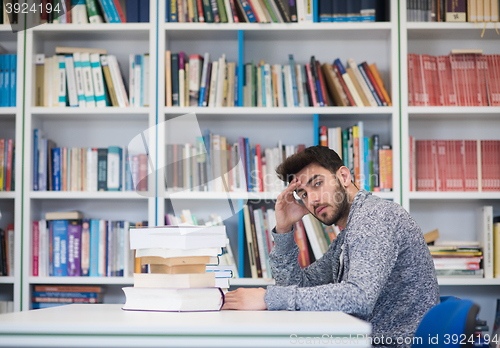 Image of portrait of student while reading book  in school library