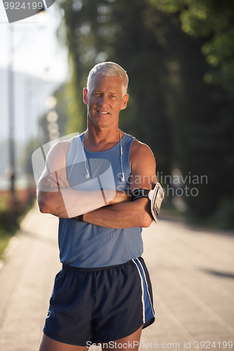 Image of portrait of handsome senior jogging man