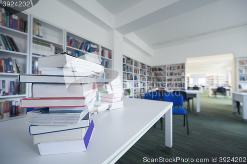 Image of female student study in library, using tablet and searching for 