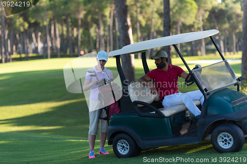 Image of couple in buggy on golf course