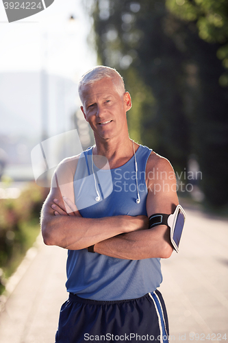 Image of portrait of handsome senior jogging man