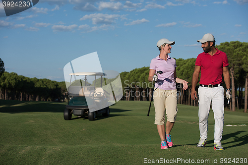 Image of couple walking on golf course