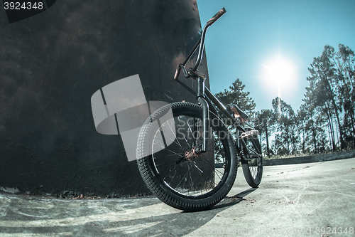Image of Bmx bike standing against black  wall