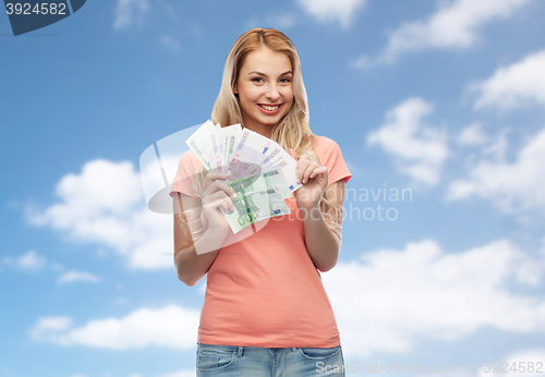 Image of happy young woman with euro cash money