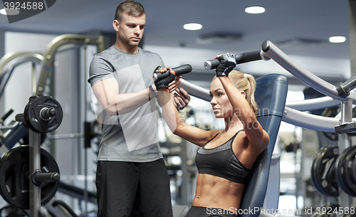 Image of man and woman flexing muscles on gym machine