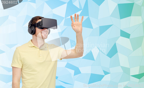 Image of happy man in virtual reality headset or 3d glasses