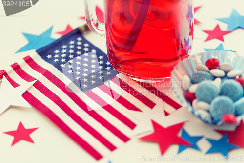 Image of juice glass and american flag on independence day