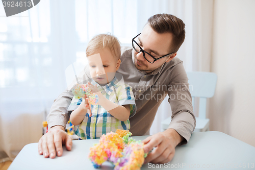 Image of father and son playing with ball clay at home