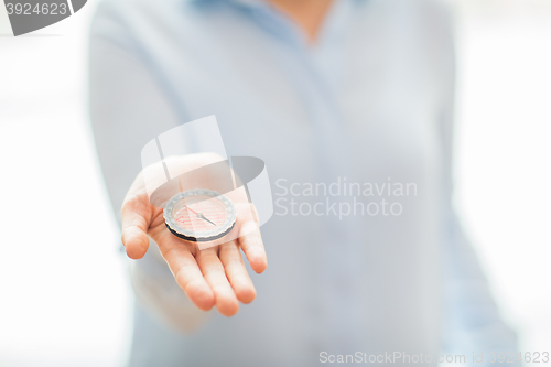 Image of close up of woman hand holding compass