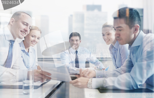 Image of group of smiling businesspeople meeting in office