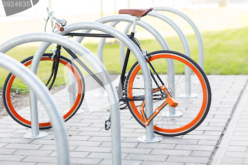 Image of close up of bicycle locked at street parking