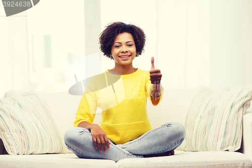 Image of happy african american young woman at home