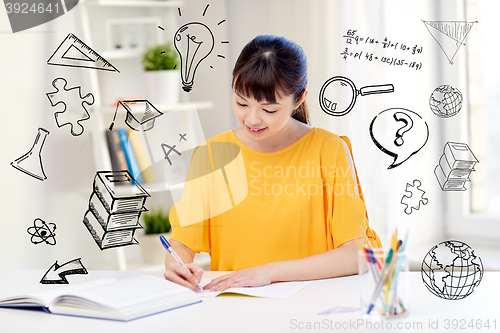 Image of happy asian young woman student learning at home