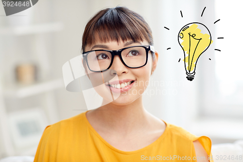 Image of asian woman in glasses with light bulb doodle