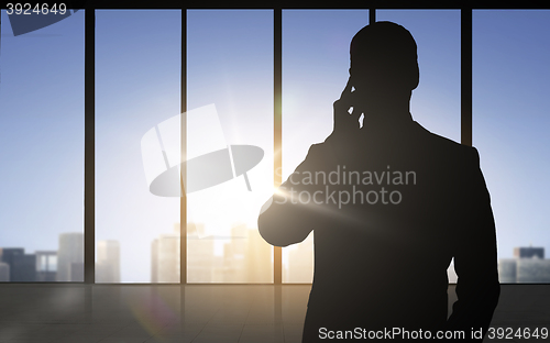 Image of silhouette of business man calling on smartphone