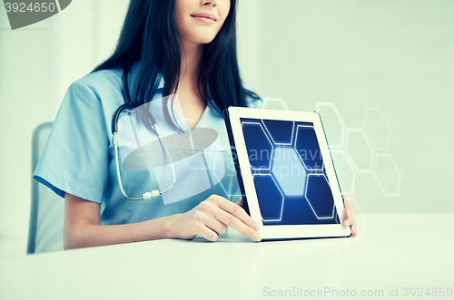 Image of close up of doctor showing hologram on tablet pc