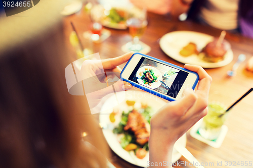 Image of woman photographing food by smartphone 