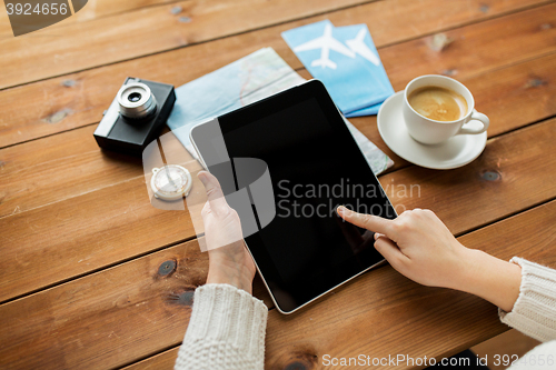 Image of close up of traveler hands with tablet pc and map