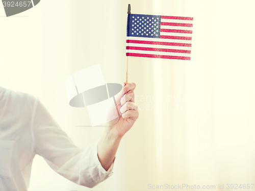 Image of close up of woman holding american flag in hand