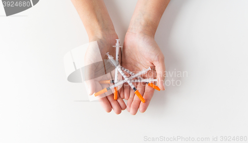 Image of close up of woman hands holding syringes