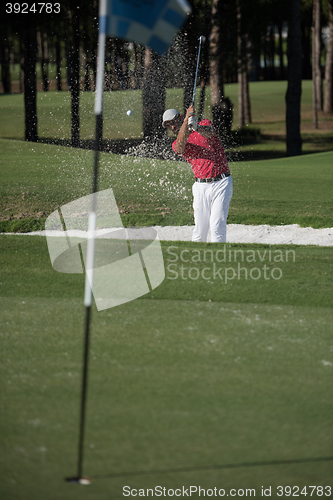 Image of golfer hitting a sand bunker shot