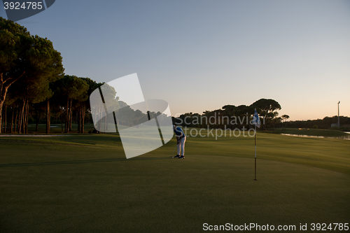 Image of golfer hitting ball to hole