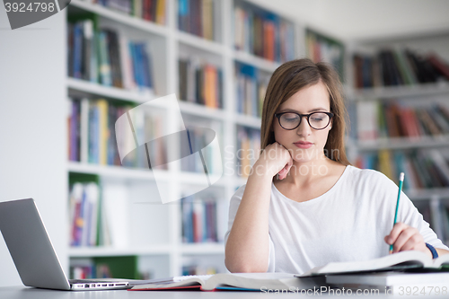 Image of female student study in school library