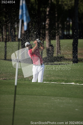 Image of golfer hitting a sand bunker shot