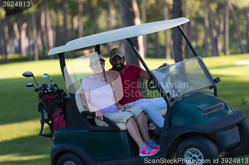 Image of couple in buggy on golf course