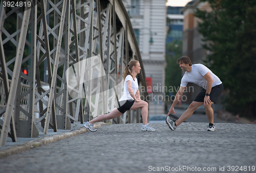 Image of couple warming up and stretching before jogging