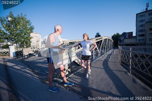 Image of jogging couple planning running route  and setting music