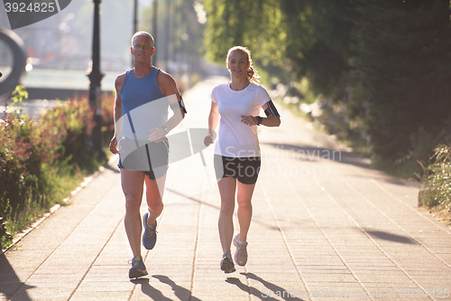 Image of couple warming up and stretching before jogging